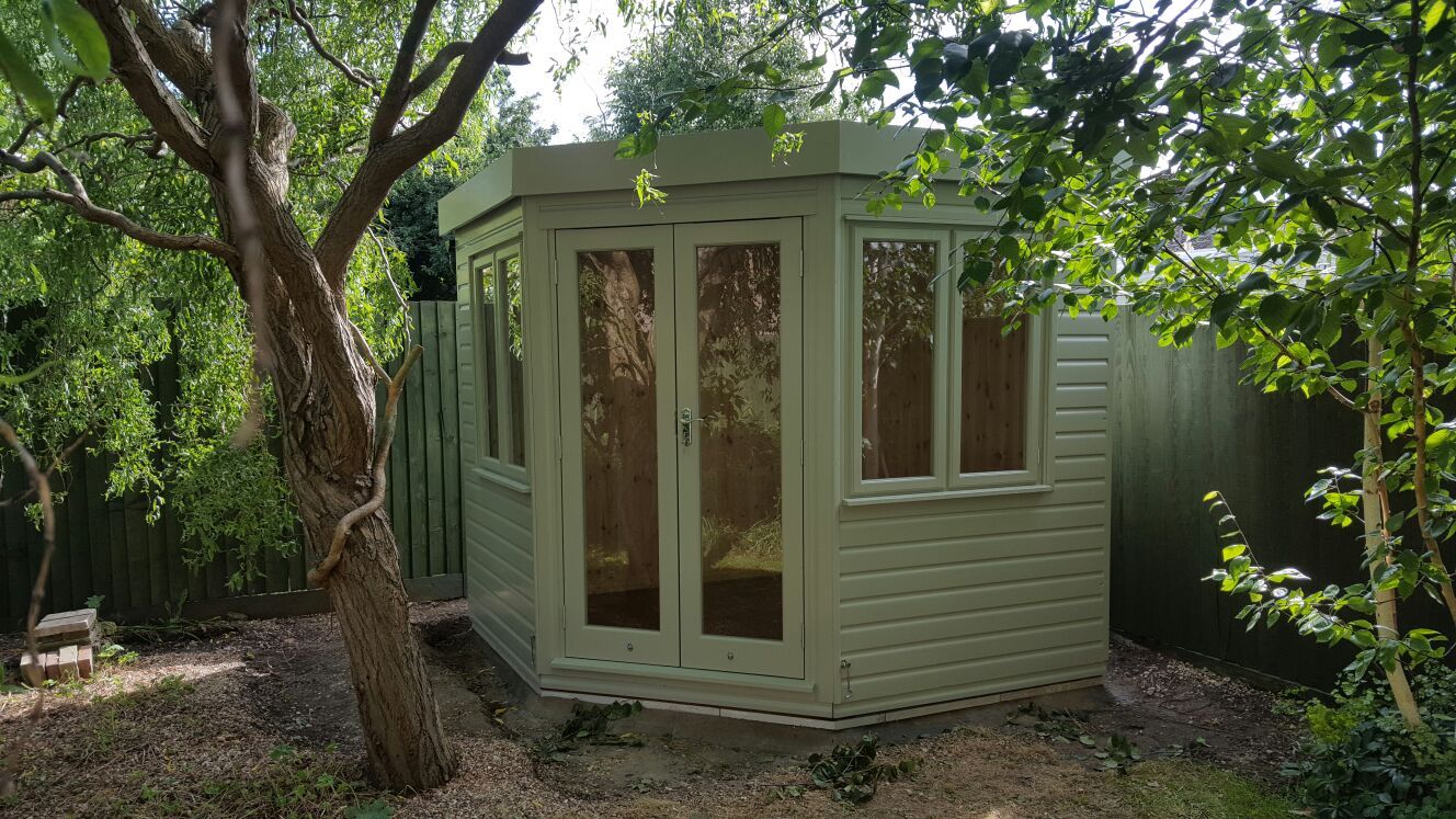 A garden office building with desk and workspace inside