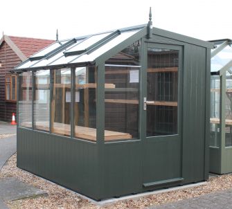 Jay 6ft 8in x 8ft 4in (2.03m x 2.55m) in optional painted finish, with guttering and high level shelf